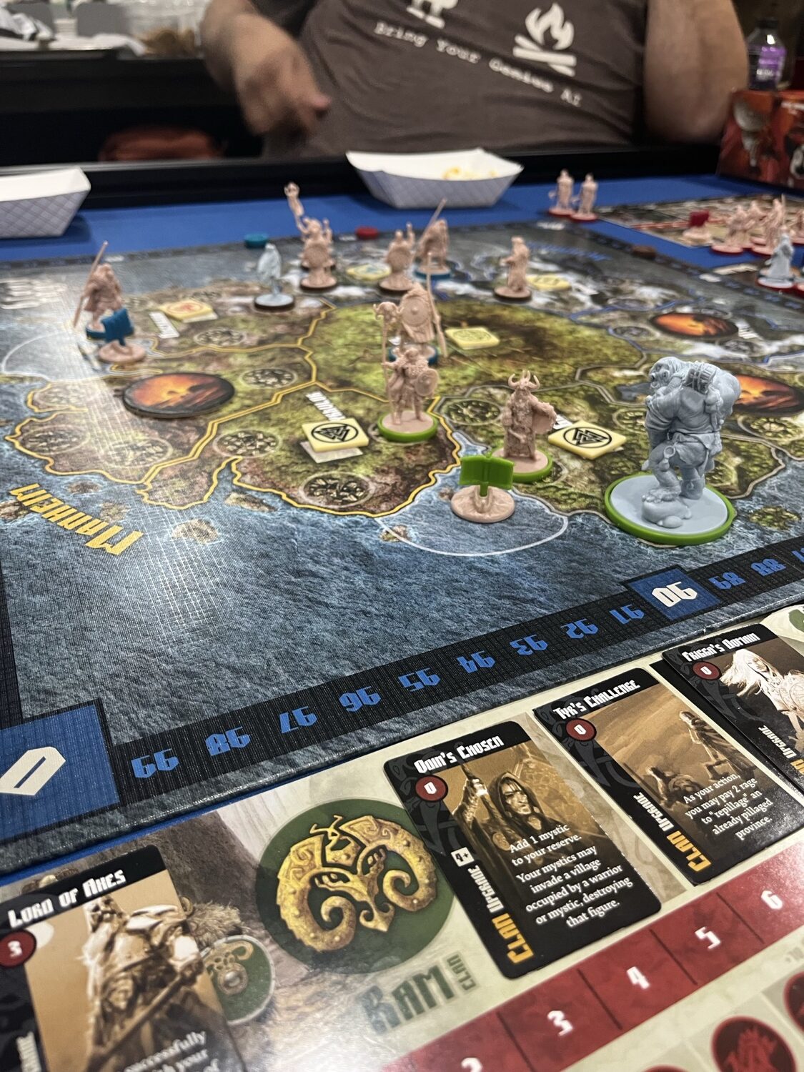 Blood Rage board late in an Age with a large monster figure and clan warriors positioned in provinces about to be consumed by Ragnarök