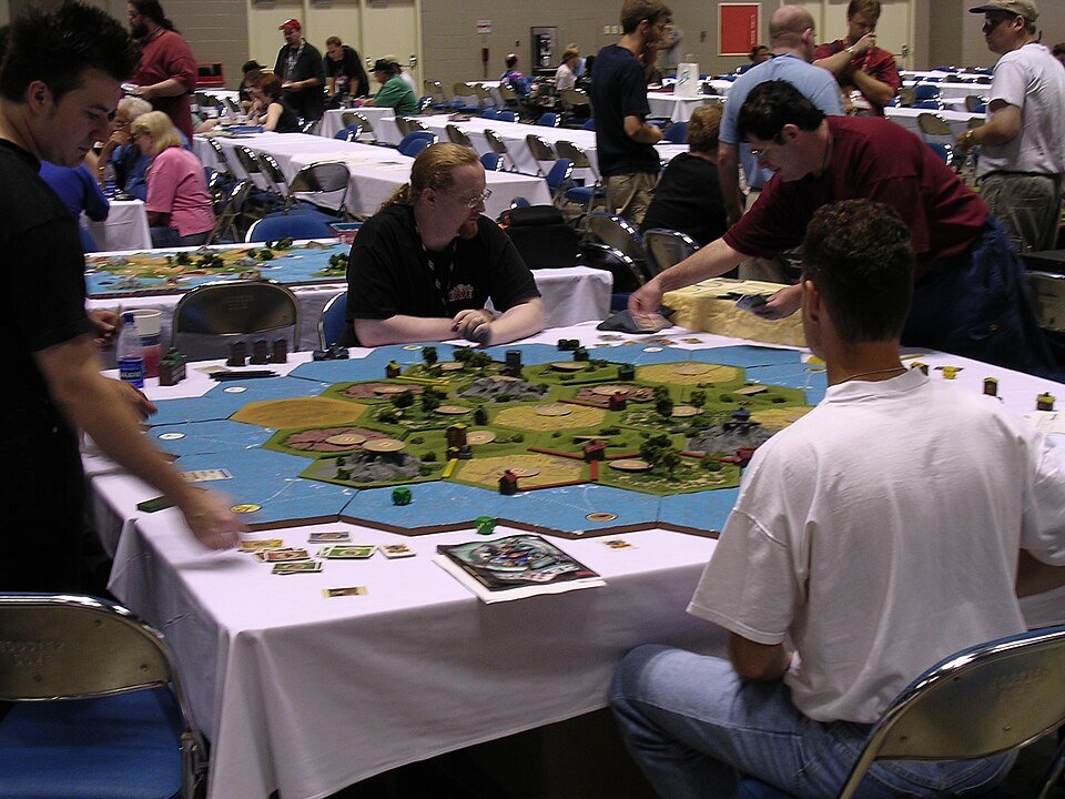 A giant Settlers of Catan game being played at a convention