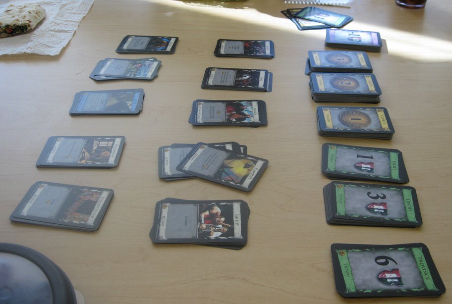 Dominion kingdom card piles laid out on a table