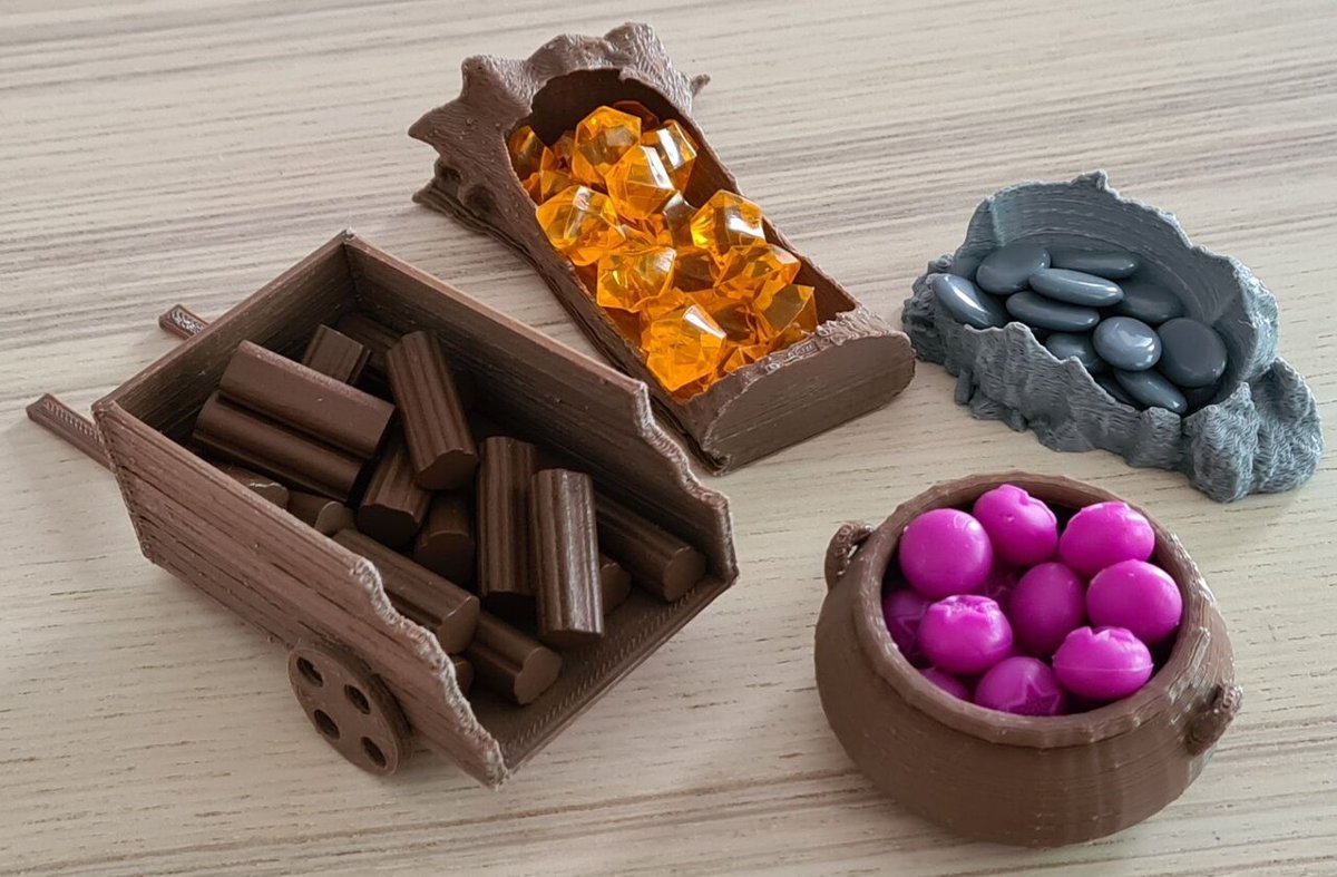 Everdell resource pieces — twigs, resin, pebbles, and berries