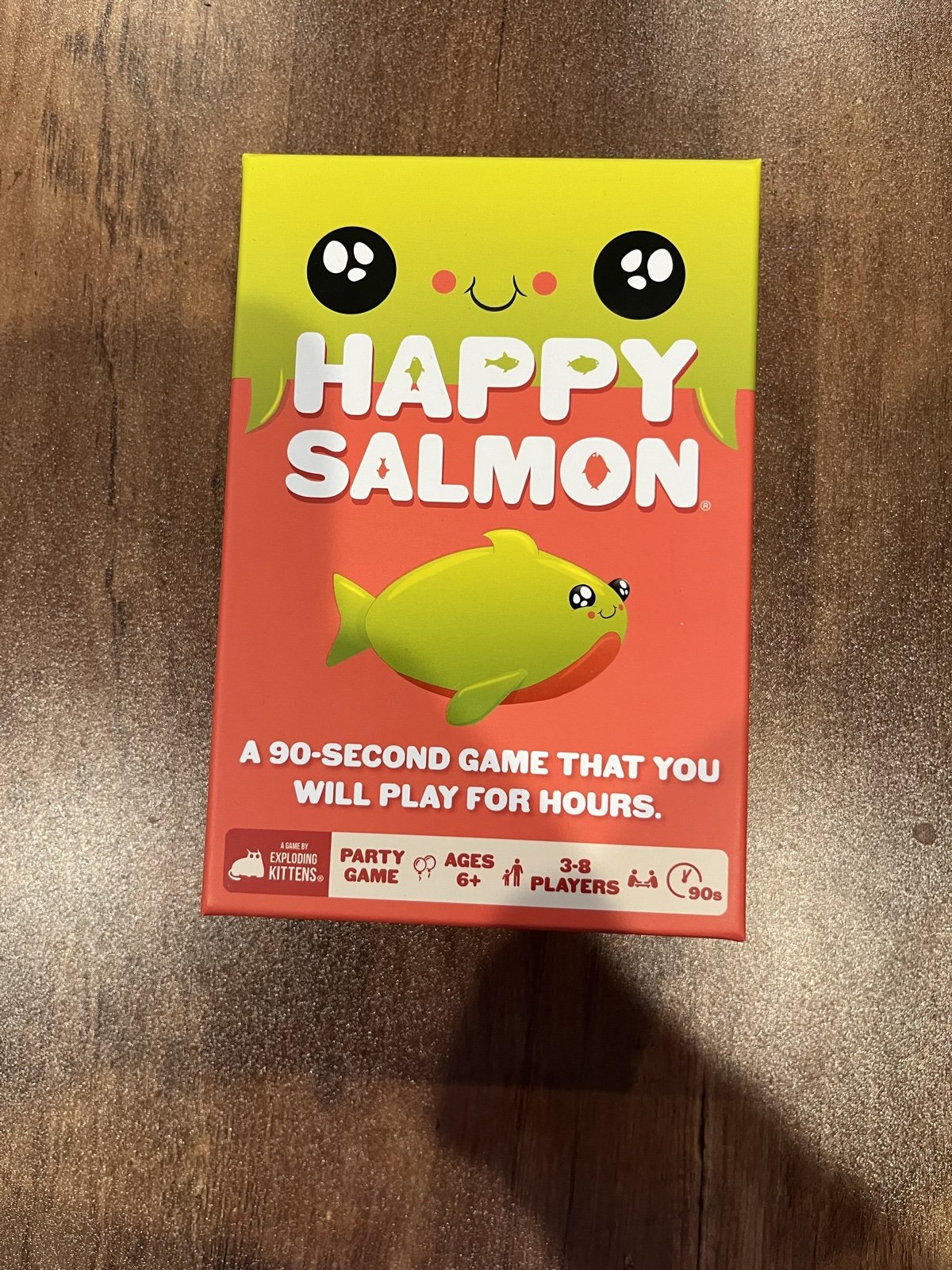 The Happy Salmon box, Exploding Kittens edition, on our game table