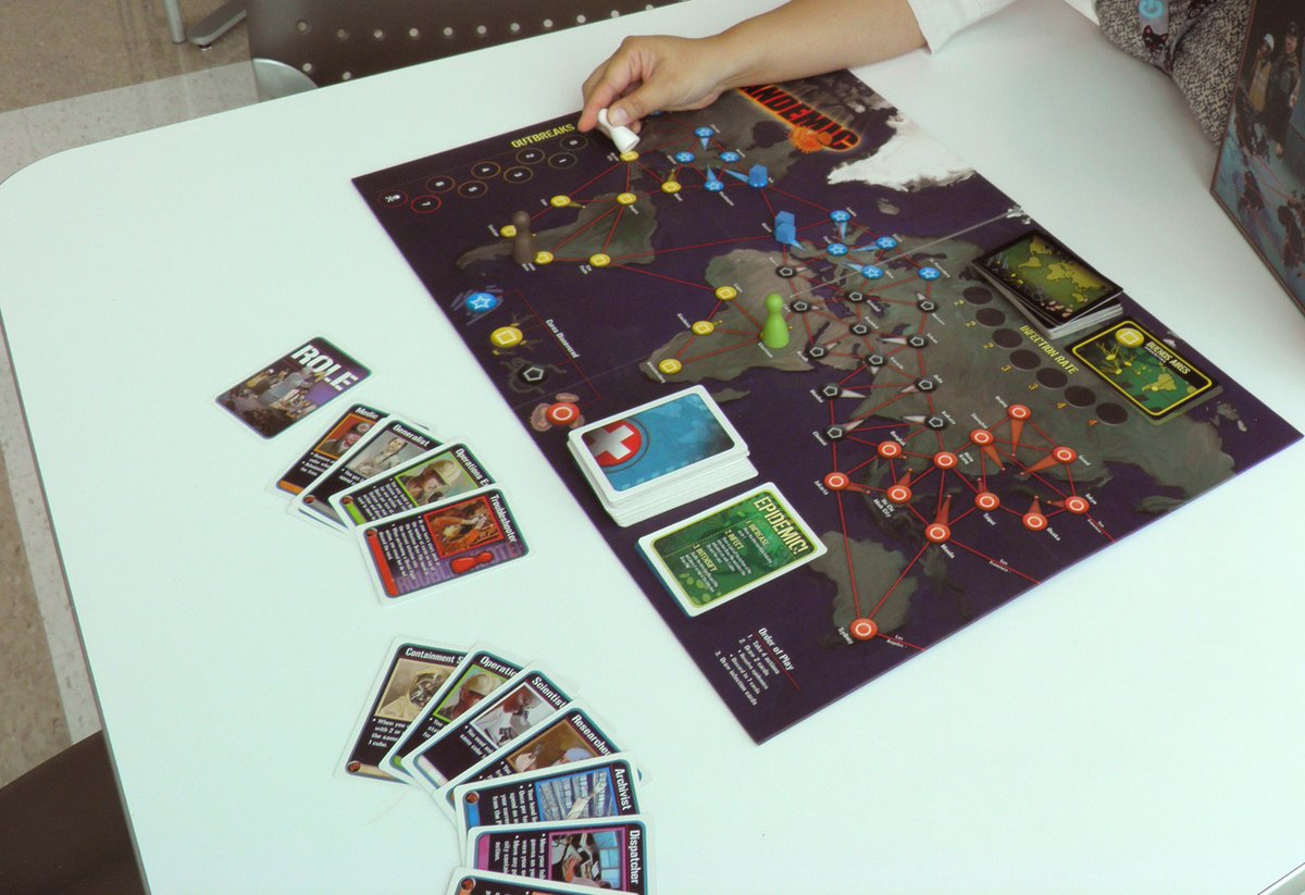 Pandemic set up mid-game with the board, disease cubes, role cards and the infection deck