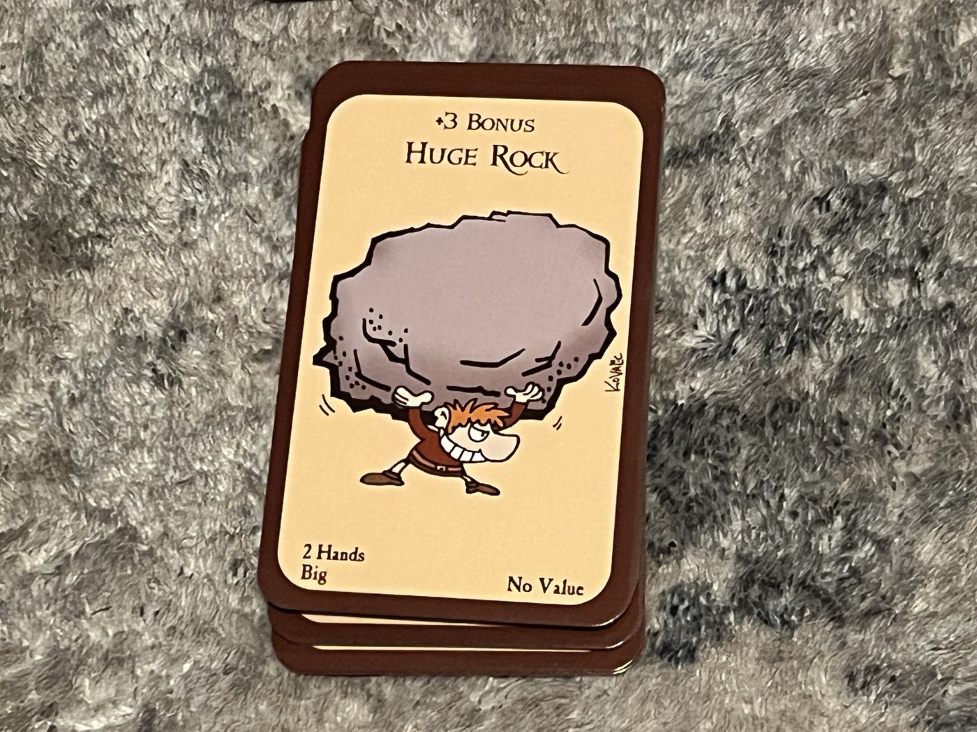 The Huge Rock card from Munchkin: +3 bonus, 2 Hands, Big, No Value