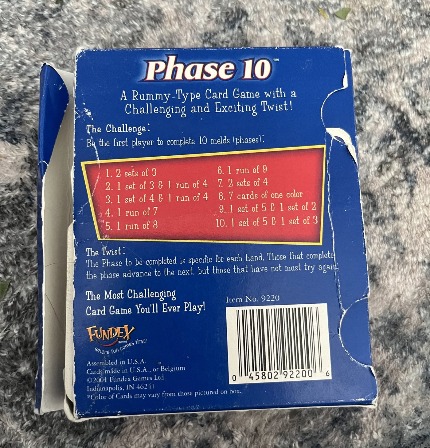 Back of a worn 2001 Fundex Phase 10 box listing the ten phases
