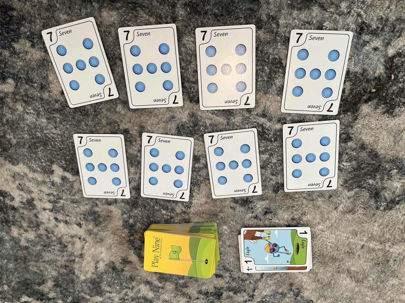 Play Nine layout with all eight cards showing 7