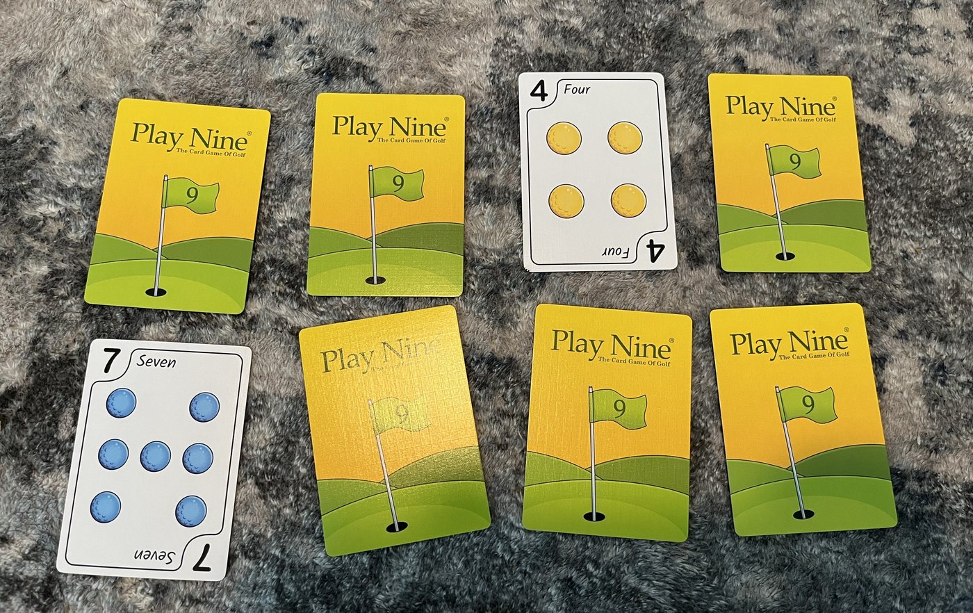 A Play Nine layout of eight cards in two rows of four with two cards turned face up