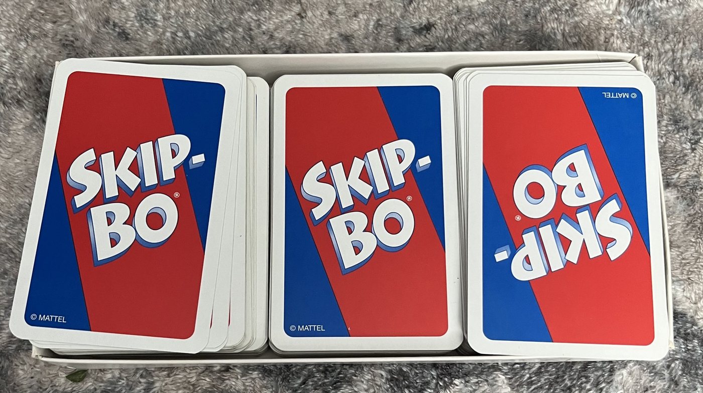 The Skip-Bo deck split into three stacks inside its box tray